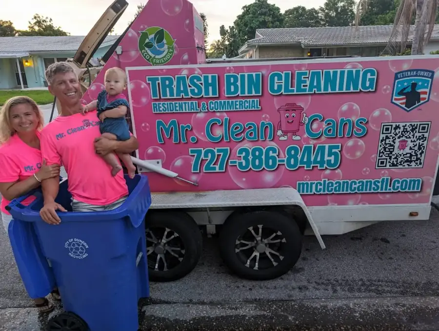 The Mr. Clean Cans team with a freshly cleaned and deodorized blue trash bin returned curbside